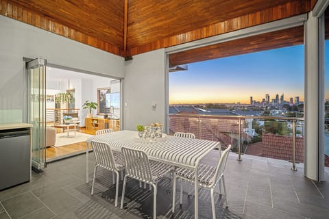 Dine comfortably in a covered outdoor space featuring a large table, and ample seating, perfect for enjoying meals and entertaining al fresco.