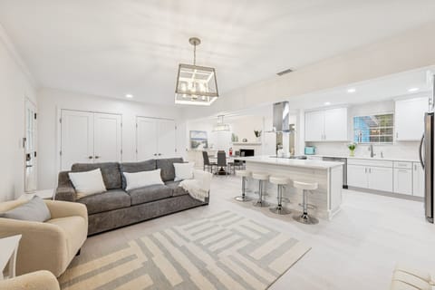 This bright and inviting space effortlessly flows into the dining and kitchen areas, creating the perfect hub for family gatherings.