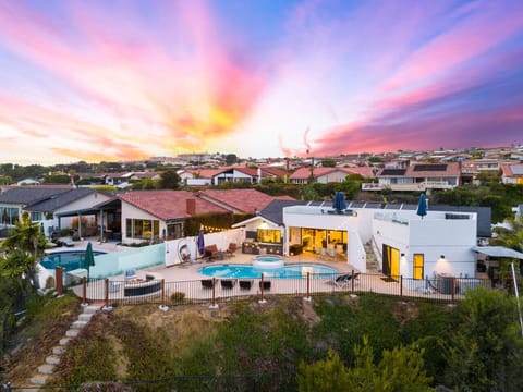 Backyard oasis complete with pool, loungers, and sweeping sunset views.