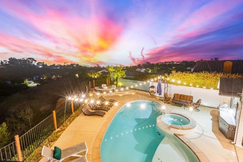 Unwind in the hot tub or pool while enjoying stunning sunset views and privacy.