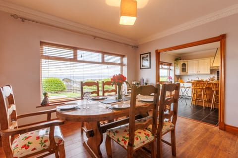 This bright and spacious dining room boasts stunning views while you enjoy a meal