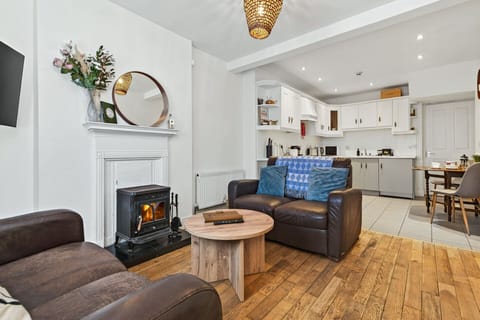 Living room with wood burning stove and open plan kitchen