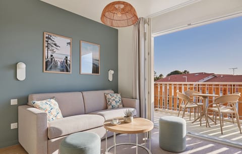 Enjoy seamless indoor-outdoor living with expansive windows in the living area that open up to your balcony, allowing plenty of natural light to brighten your stay.