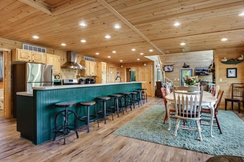 Open-concept kitchen and dining area with ample seating for large groups.