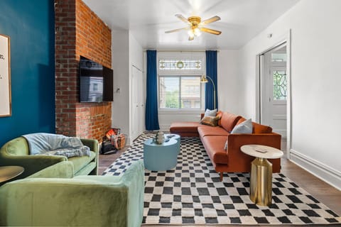Midcentury modern themed living room with windows with curtains