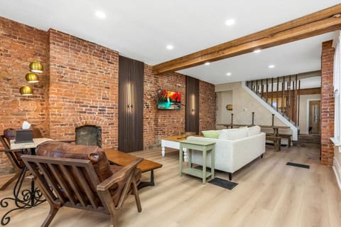 Relax in the living room with exposed brick and cozy seating. 