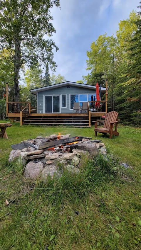 Lakefront cottage with deck and firepit in Manitoba.