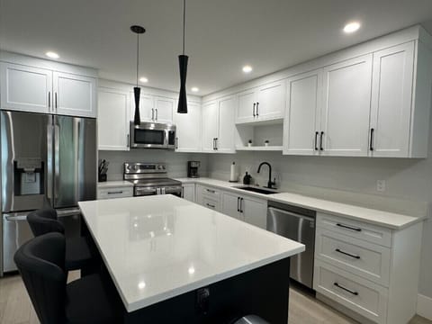 Enjoy the fully stocked kitchen with plenty of counter space, stainless steel appliances, and all the essentials to make dining in a breeze.