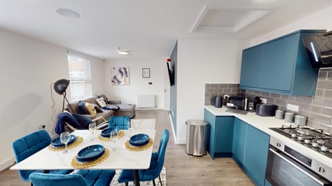 Unwind in the bright living space, featuring a comfortable sofa bed and large Smart TV—perfect for relaxed evenings, movie nights, or accommodating an extra guest with ease