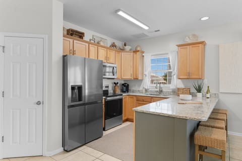 Your fully-equipped kitchen invites you to prepare meals with modern appliances, granite counters, and ample cabinet space. Gather around the island for casual dining or morning coffee in this bright, welcoming space.