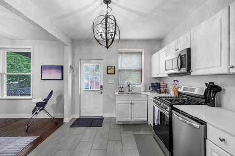 This stylish and functional kitchen offers everything you need—from a Keurig coffee station to family-ready seating with a high chair, perfect for group stays and family vacations.