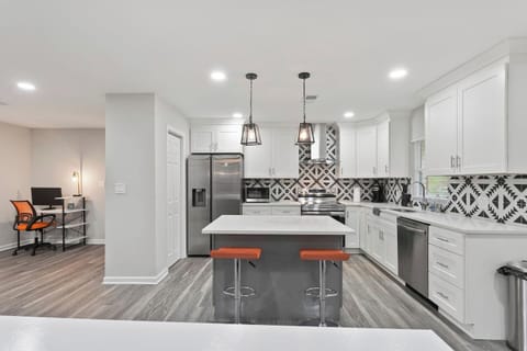 Open concept layout, where the kitchen island seamlessly connects to the welcoming living room.