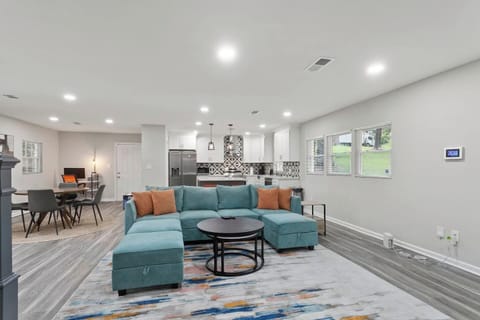 Seamless togetherness and personal space coexist in this inviting living room. From this vantage point, you can glimpse the kitchen and workstation, allowing family and friends to stay connected while attending to their individual activities.