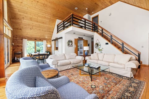 Open great room includes living area, dining area, kitchen, + small landing