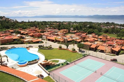 Aerial View | Panoramic perspective of the property showcasing the infinity pool, jacuzzi, tennis court, and stunning Lake Chapala views