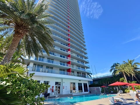 Outdoor pool surrounded by high-rises and cityscape views.