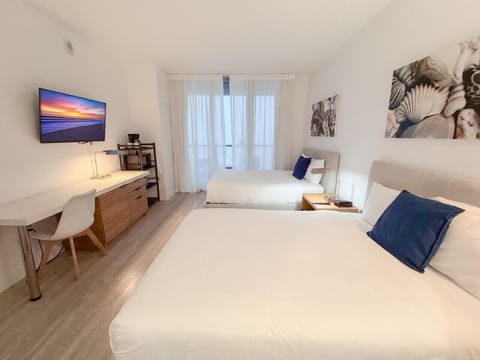 Spacious bedroom with balcony access and Smart TV.