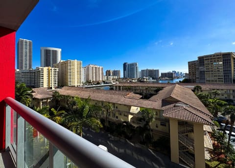Private balcony with chairs and open city views.