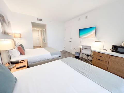 Bedroom with 2 full-size beds and a TV