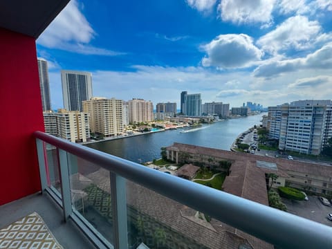 Private balcony with chairs and open city views.