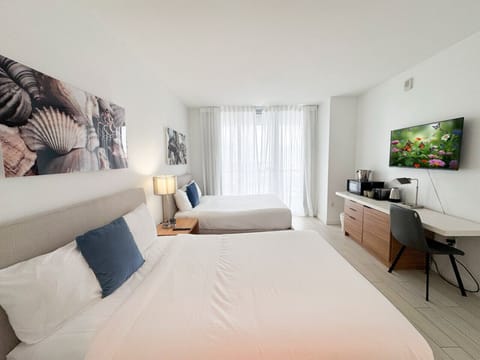 Spacious bedroom with balcony access and Smart TV.