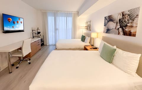 Spacious bedroom with balcony access and Smart TV.