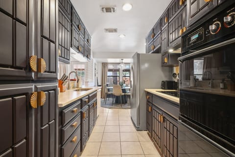Enjoy plenty of storage with ample cabinetry and whip up culinary delights using top-of-the-line, high-end appliances.