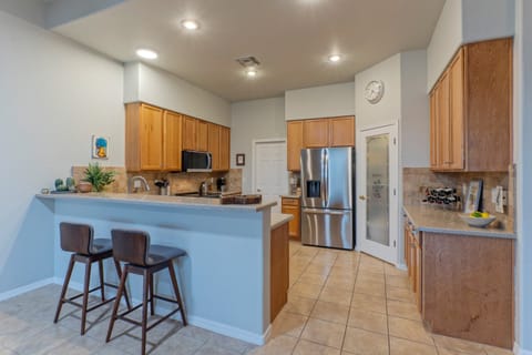 Open concept and modern kitchen has counter seating and everything the chef desires.