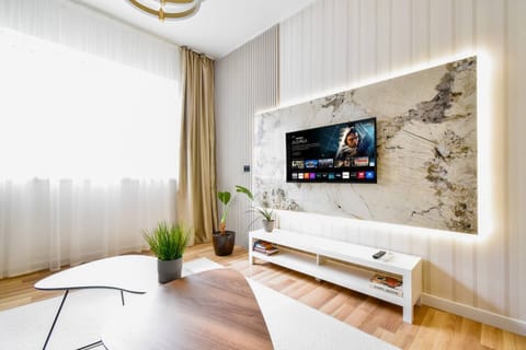 Unwind in the comfortable living area, where soft natural light meets modern decor and a Smart TV for cozy nights in.