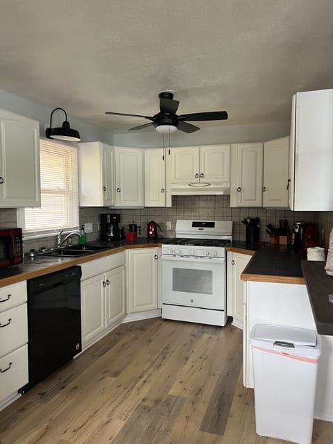 Fully furnished Kitchen with Gas stove, microwave, dishwasher & refrigerator.