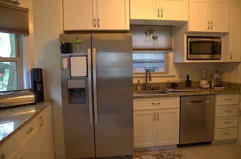 Refrigerator, microwave, and dishwasher in the kitchen area.