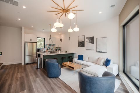 Bright and spacious open-concept living room featuring curated décor, luxury furnishings, and abundant natural light throughout.