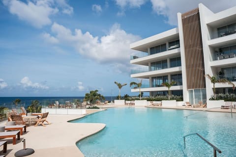 Spacious pool terrace with loungers and panoramic sea views for guests to enjoy.