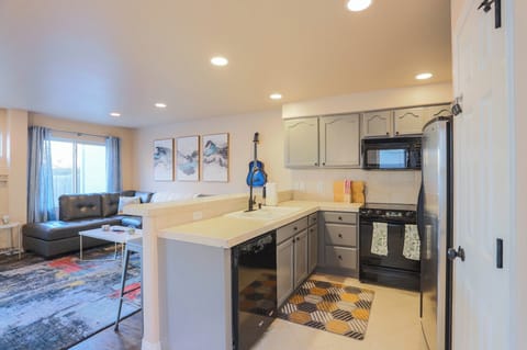 The equipped kitchen features a full sized dishwasher, stainless steel fridge, microwave, oven, coffee maker, and more!