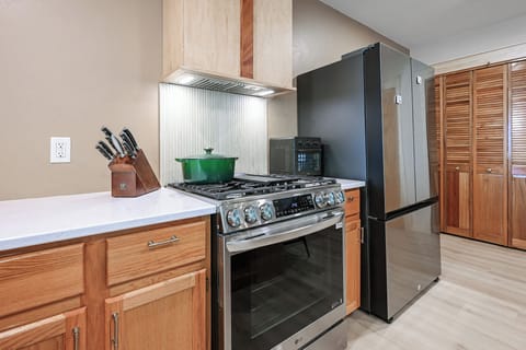 The kitchen is perfectly situated in the center of the upper level.  This allows for meals to be prepared while still allowing you to visit with your family and friends in the dining rooms or on the day beds.  Bonus:  The kitchen also has panoramic lake views!