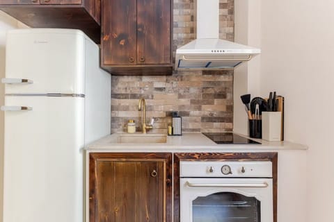 Kitchen: Beige marble sink and countertop and cooking area