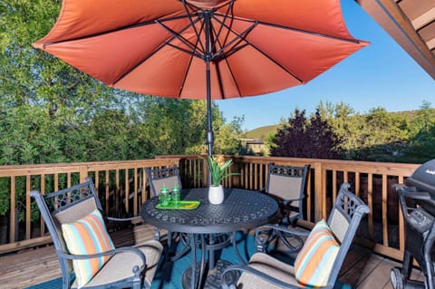 Large deck for relaxing, with table, chairs, umbrella, hammock, & BBQ Grill. 