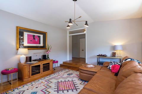 The large living room has classic barware, a turntable and vinyl.