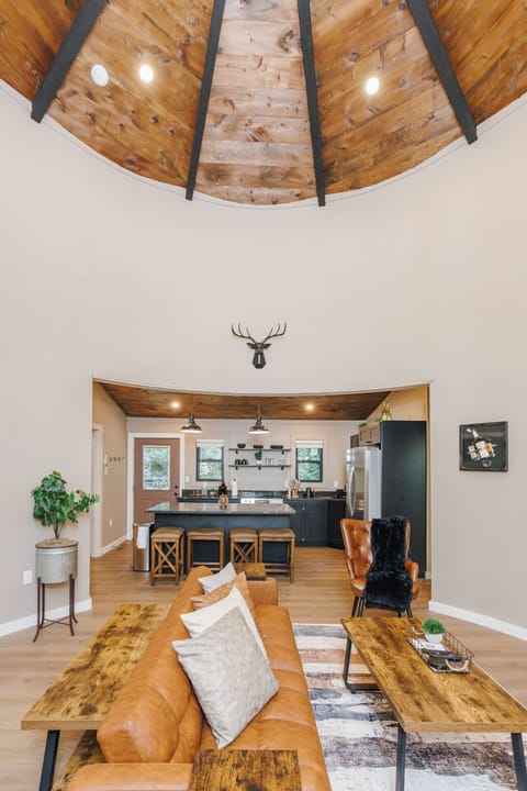 Gather in the spacious living room with its striking vaulted ceiling and warm wood accents. The seamless flow to the kitchen makes this cabin ideal for cooking, relaxing, and connecting.