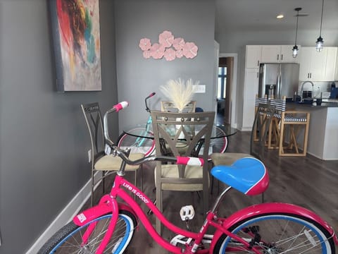 Dining Area: Bright space with chic decor, a glass table, and fun bikes for local adventures!