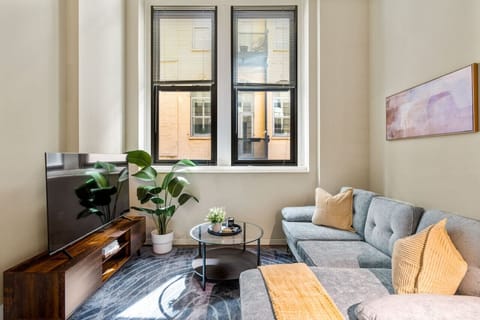 The living room’s plush seating beckons you to sink in and relax, surrounded by light and airy decor.