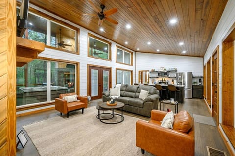 Unwind in this airy retreat with forest views and warm wood tones.