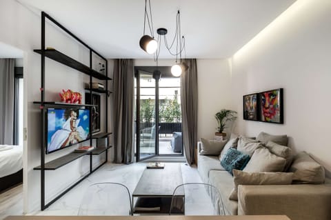 Sunlit living area opens to private balcony, creating spacious comfort perfect for relaxing evenings.