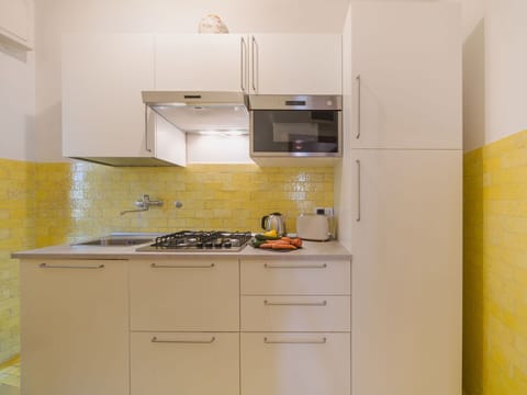 Kitchen, Kitchen Appliance, Countertop, Major Appliance, Wall, Flooring, Wood, Interior Design, Cabinetry, Yellow