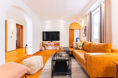 Inviting sitting area with a mustard-yellow sofa and stylish decor elements.