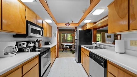 Galley kitchen with passthrough to living and opens to dining
