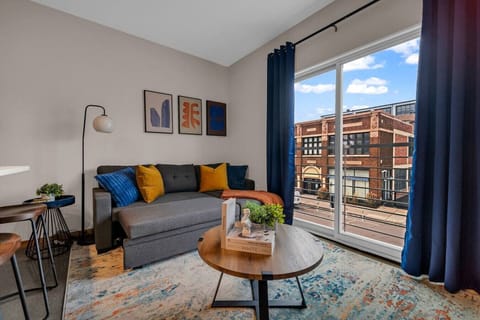 The living room is filled with natural light, creating a bright and welcoming space that invites relaxation.