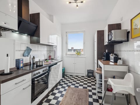 Die helle, voll ausgestattete Küche mit modernem Design und gemütlicher Sitzecke bietet alles, was man zum Kochen und Genießen braucht.