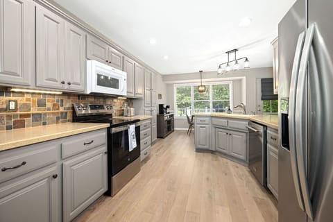 Whether you're preparing delicious meals in the fully equipped kitchen or enjoying a card game at the dining table, the seamless flow of this space ensures everyone can be part of the fun.