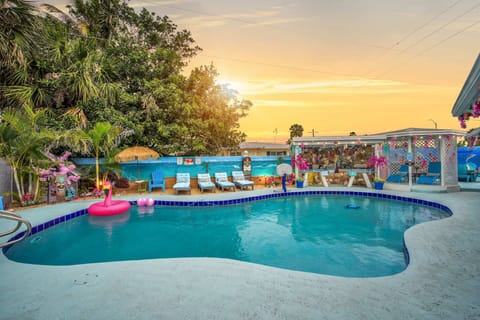 Relax by the pool with tropical decor and sunset views in this inviting outdoor space.